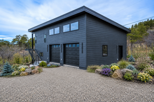 Charcoal gray detached garage with black metal staircase